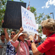 Retired school teacher Carmen Rubio from El Paso (center) argues with a so-called “counter protester” outside of the Clint Border Patrol station on July 1, 2019 in Clint, Texas.